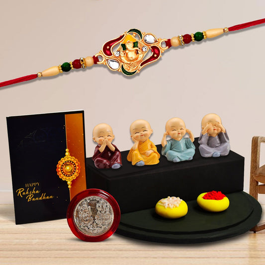 Ganesha With Green And Red Mina Rakhi With Decorative Baby Buddha Gift ,Silver Color Pooja Coin, Roli Chawal & Greeting Card - Needs You